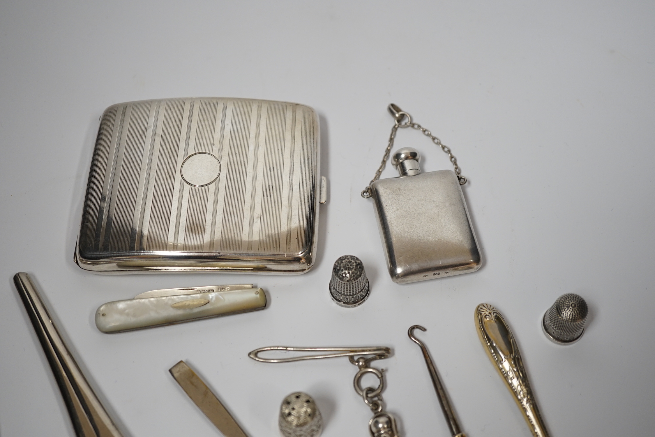 A George V silver cigarette case, Adie Bros. Birmingham, 1929, two silver and two sterling mounted button hooks and seven other items including propelling pencil in case, fruit knife and Italian 800 standard scent flask.